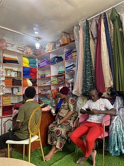 Junior mumbere in his boutique planing how to give help
