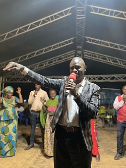 Junior mumbere together whith pastor araali kandole moses in a croused in karugutu